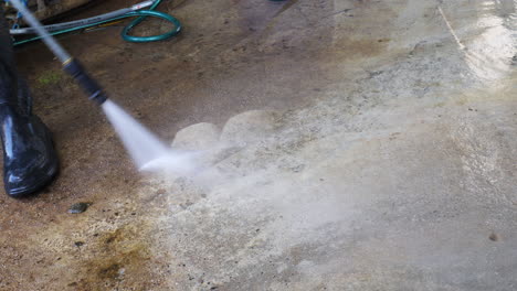 high pressure jet washing dirt of concrete flooring