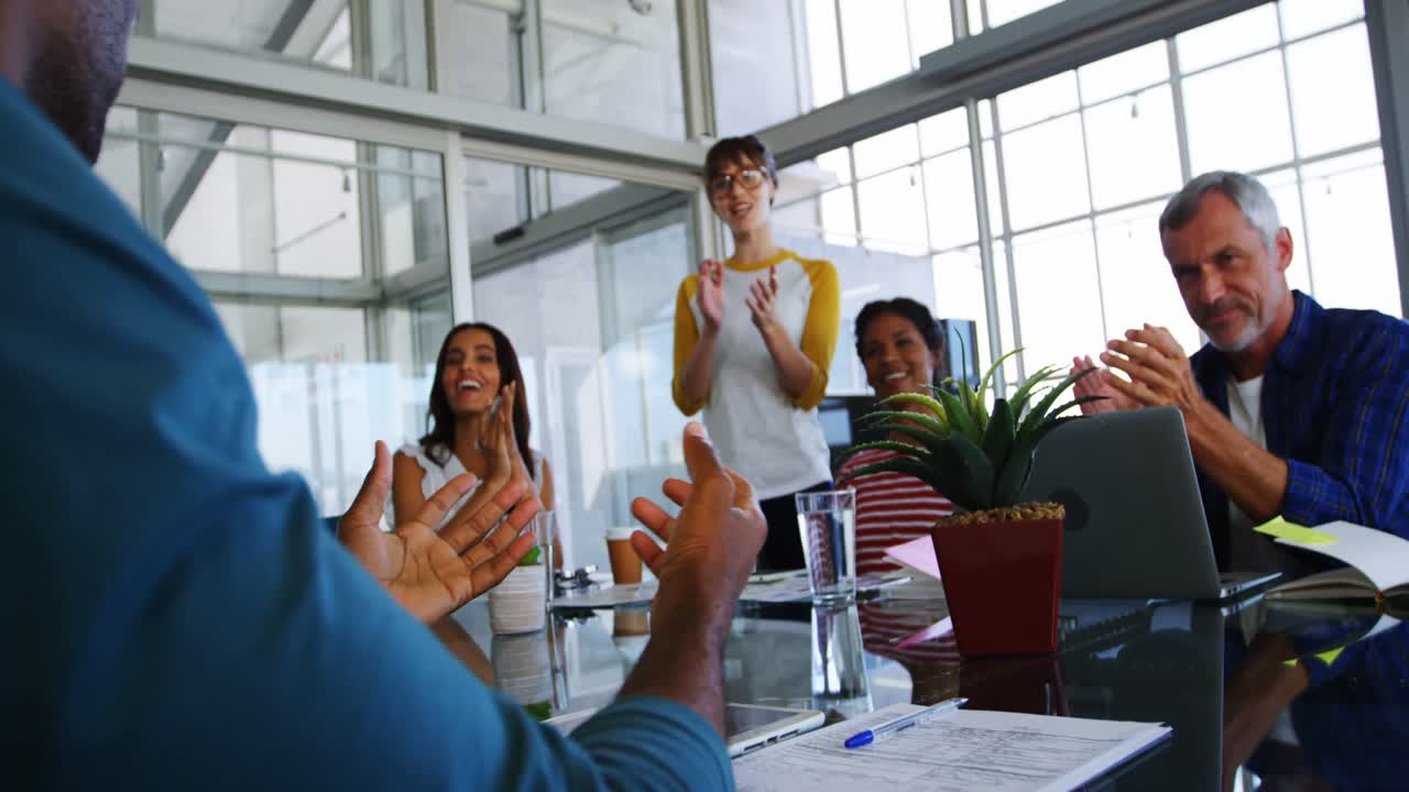 Business executives applauding after presentation