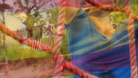 animación de la bandera de españa sobre una mujer caucásica durante el entrenamiento de una carrera de obstáculos