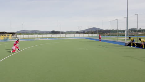 female hockey players preparing for penalty corner on outdoor field