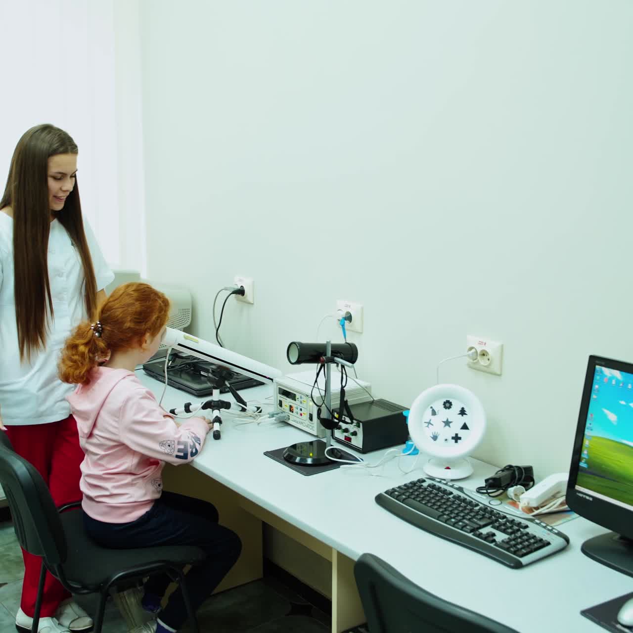 Doctor examining little child girl