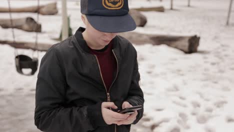 a person smiles as they text on their phone