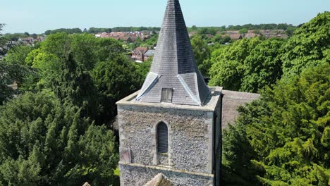 slow rising crane shot of a church tower in a kent village called littlebourne