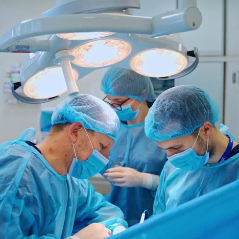 group of neurosurgeons performing an operation. teamwork of doctors in protective uniform working in medical center.