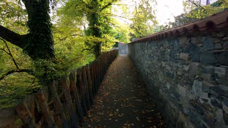 narrow alley around stone walls on a sunny day in nature