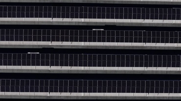 Top down view of rooftop solar panel array with horizontal photovoltaic grid pattern