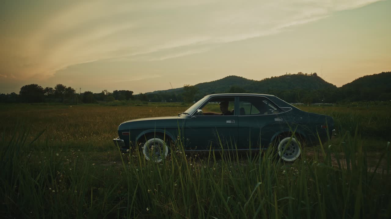 Vintage Car in a Rural Sunset Landscape