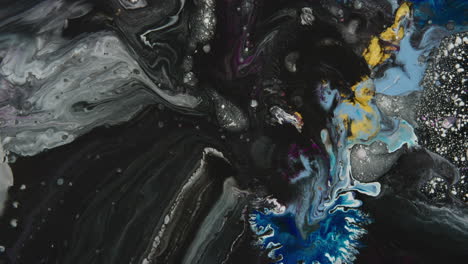 líquido negro abstracto entre puntos blancos, azules y amarillos