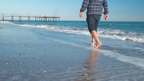 man walking on the beach