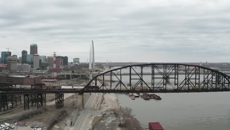 slow motion aerial parallax of train crossing bridge over mississippi river