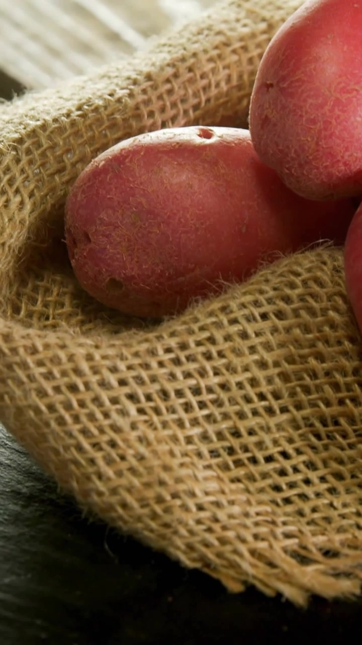 Vertical video: White cursor entering UI animating crop shifting red spuds revealing for marketing