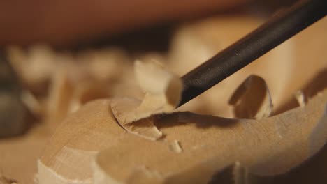 close-up of a craftsman carving wood