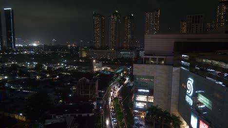 night time illumination jakarta city downtown traffic street famous mall rooftop panorama 4k indonesia