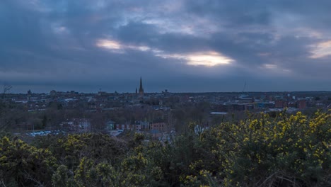 Timelapse-shot-of-Norwich-Cathedral-in-distance-located-in-Norwich,-Norfolk,-UK-during-evening-time