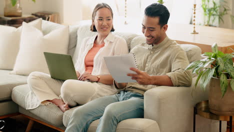 Happy-couple-with-paper-or-planning-on-laptop