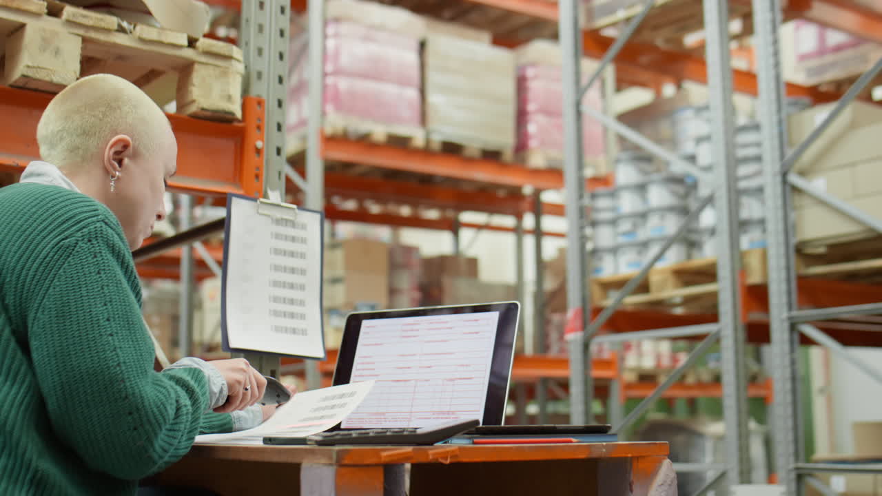 Female Warehouse Manager Working with Scanner and Laptop