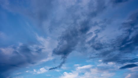 Blue-sky-with-very-graphic-cloud-trails,-wide-shot-filmed-in-timelapse