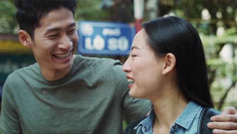 Handheld-view-of-Vietnamese-couple-walking-in-the-city