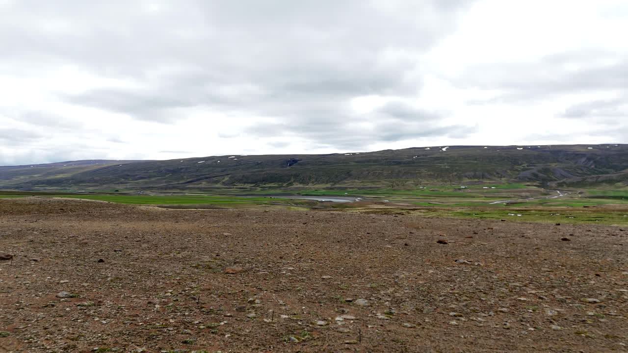 Aerial drone footage of Road 1 Ring Road in Austurland, Iceland showing winding road, surrounding terrain, and landscape from above