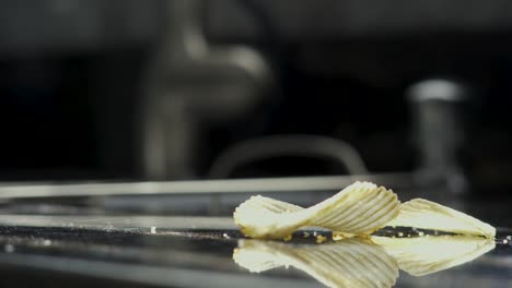 potato chip falling onto counter in kitchen