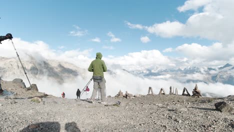 hikers on a mountain top with clouds