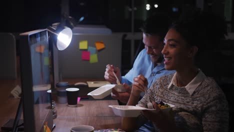 Office executives eating and discussing in a modern office