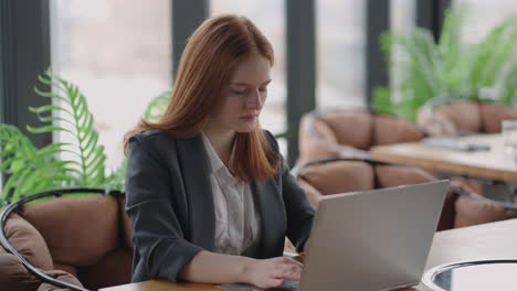 Una-Mujer-Independiente-Está-Trabajando-Con-Un-Cuaderno-En-Un-Restaurante-Navegando-Por-Internet-En-Busca-De-Información