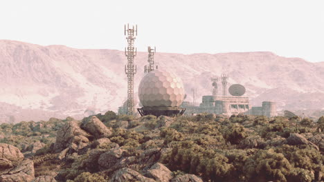 military communications facility located in mountainous terrain during daylight