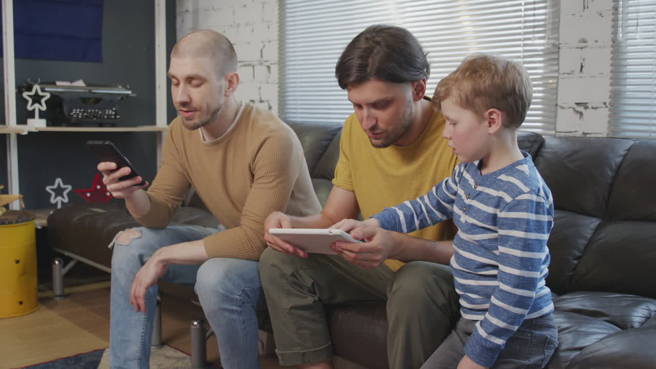 Men and Boy Using Gadgets at Home