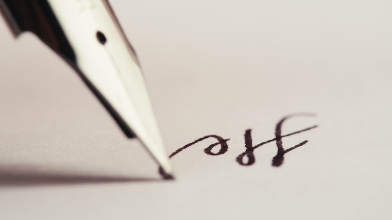 Elegant Fountain Pen Writing the Word 'Hello' on Paper