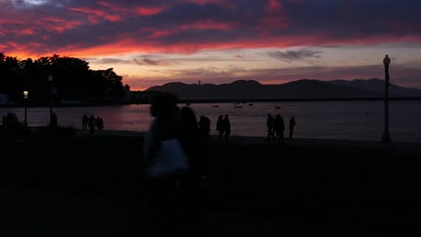 siluetas de turistas bajo la puesta de sol en san francisco