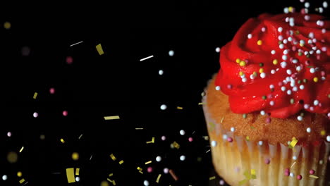 cupcake with red frosting and sprinkles, surrounded by falling confetti animation