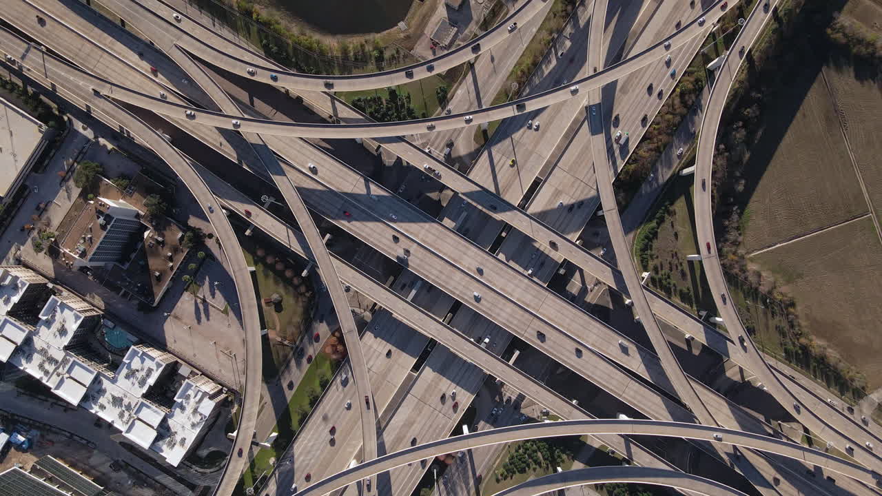 Top-down aerial view of Interstate I-10 freeway and Bellway 8 Houston Texas. Rotating Bird Eyes shot of the intersection at I-10 west and Sam Houston Tollway in Houston Texas. Counter-clockwise rotate