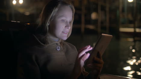 Woman-Using-Tablet-PC-while-Traveling-by-Water-Tram-in-Venice-I