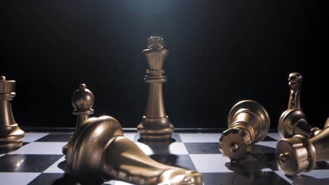 gold king chess piece in checkmate toppled over after defeat