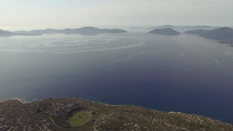 Flight-over-desert-islands-and-colorful-sea,-Brijuni-park,-Croatia