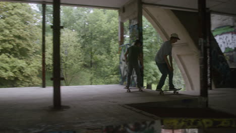 caucasian boys skateboarding in a ruined building.