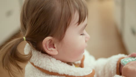 Funny-3-Year-Old-Girl-In-Ponytails-Making-A-Phone-Call-On-Calculator-Inside-A-Shopping-Mall