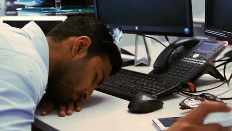 tired business executive sleeping on his desk