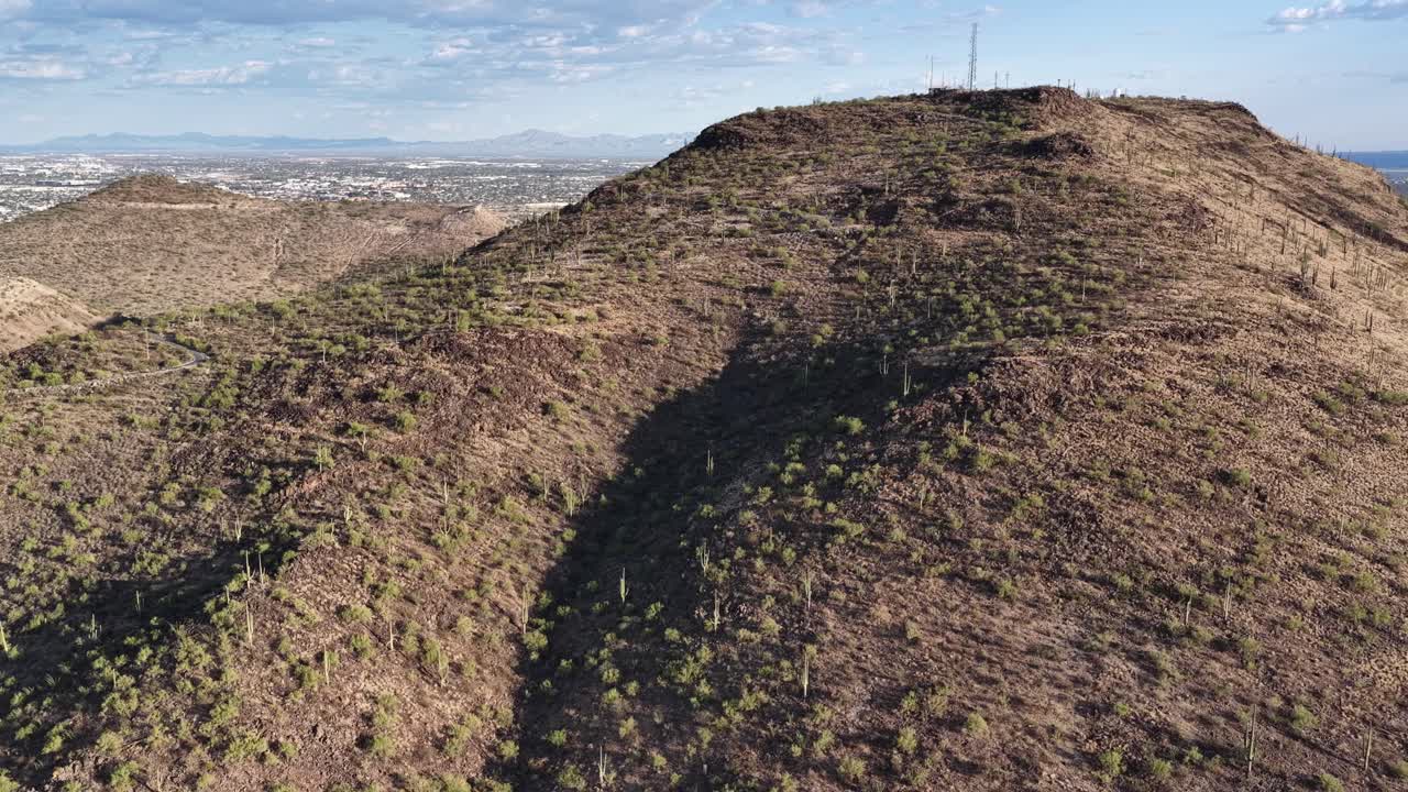 Ascending drone shot of peak of Tumamoc Hill in Tucson, Arizona