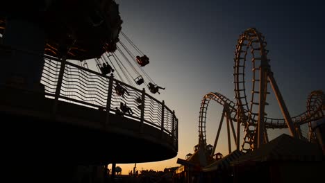 carnival rides during sunset in slow motion