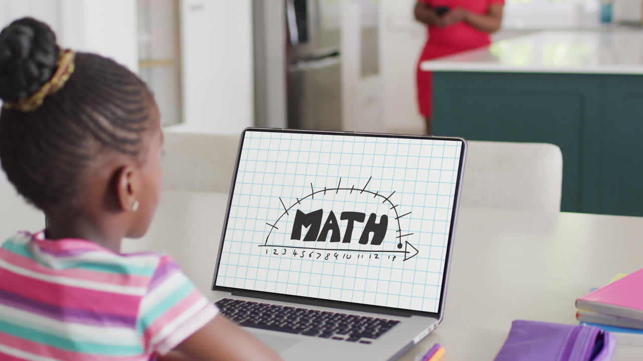 African american girl using laptop with math text on screen
