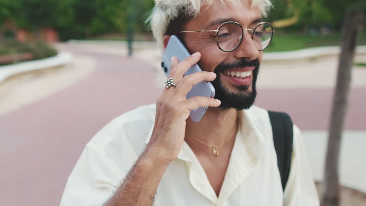 Happy Man Talking on Smartphone in a Park