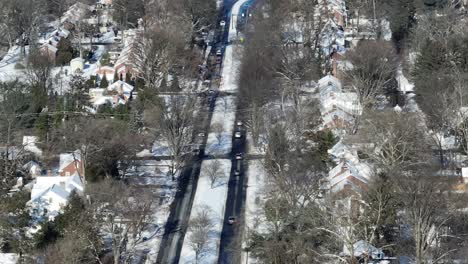 Beautiful-snowy-city-in-winter-with-driving-cars-on-main-road