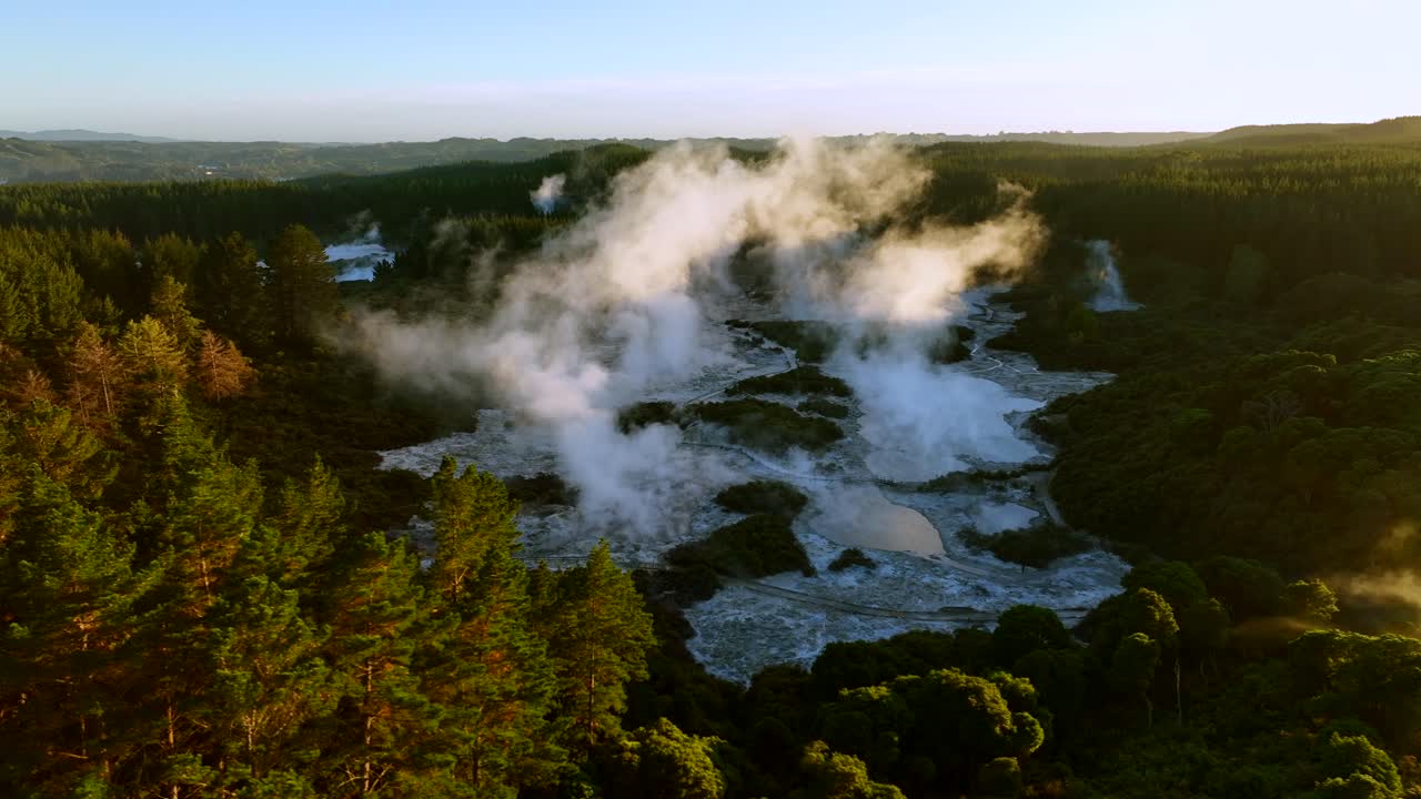 Wide landscape, Drone slowly flying over geothermal landscape. Trees, steam, bubbling mud and steam. Alien Landscape. Sci-fi. Global Warming