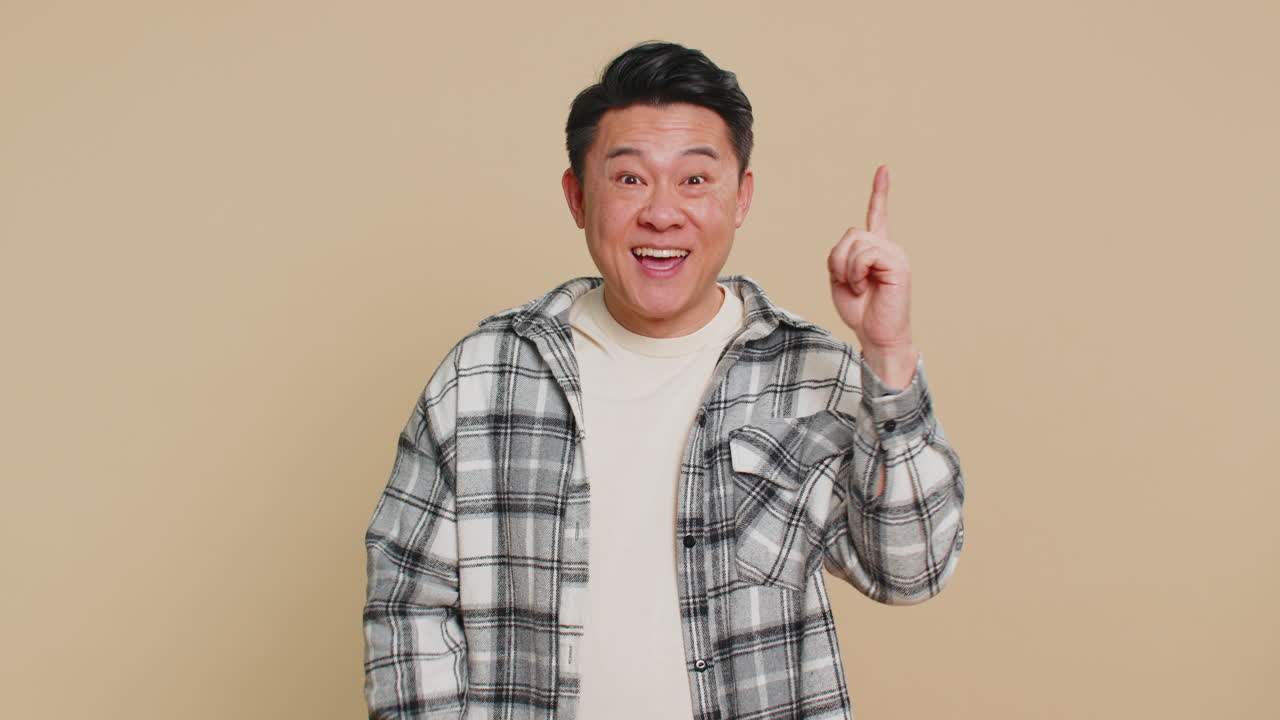 Inspired asian man having good idea plan startup showing inspiration motivation eureka gesture