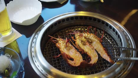 fresh ise-ebi, japanese spiny lobsters halved and placed on barbecue grill 4k