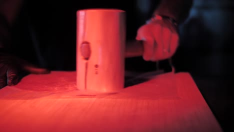 Tenderizing-piece-of-beef-meat-with-wooden-mallet,-close-up