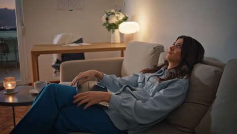 calm girl relaxing sofa closing tablet at night home closeup. woman laying couch