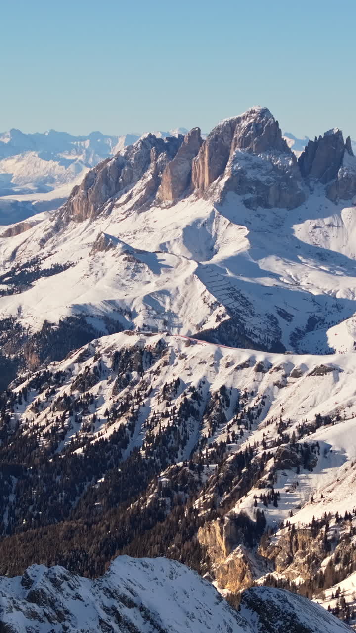 Aerial drone view of the Marmolada mountain in the Dolomites, northeastern Italy with the blue sky on the background. Vertical
